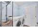 Bright laundry room featuring modern appliances, storage, and easy access to the outdoors at 1309 Llewellyn Rd, Mount Pleasant, SC 29464