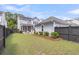Fenced backyard with green grass and mulch beds surrounding the house at 1392 Founders Way, Mount Pleasant, SC 29464