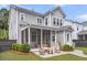 A gray two-story house with a screened-in porch and a manicured backyard at 1392 Founders Way, Mount Pleasant, SC 29464