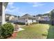 Well-maintained backyard with a detached garage and lush green lawn at 1392 Founders Way, Mount Pleasant, SC 29464