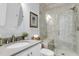 Bright bathroom with a glass-enclosed shower, gray tiled walls, and vanity sink at 1392 Founders Way, Mount Pleasant, SC 29464