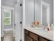 Bright bathroom with a light countertop and a vanity with dark wood cabinets at 1392 Founders Way, Mount Pleasant, SC 29464
