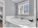 Soaking tub in a modern bathroom with marble surround, perfect for relaxation and spa-like comfort at 1392 Founders Way, Mount Pleasant, SC 29464