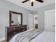 Comfortable bedroom with a large dresser, a bed, and natural light, ideal for relaxation and rest at 1392 Founders Way, Mount Pleasant, SC 29464