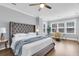 Serene bedroom with a tufted headboard bed, natural light, and a comfortable sitting area at 1392 Founders Way, Mount Pleasant, SC 29464