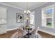 Cozy dining area with a glass table, chandelier, and natural light from the window at 1392 Founders Way, Mount Pleasant, SC 29464
