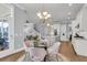Inviting dining area with a glass table, chandelier, and view into the kitchen and living spaces at 1392 Founders Way, Mount Pleasant, SC 29464