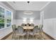 Bright dining room with wainscoting, elegant chandelier, and light blue accent wall at 1392 Founders Way, Mount Pleasant, SC 29464