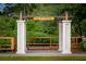Welcoming entrance sign for 'Midtown' with a charming wooden fence and lush greenery at 1392 Founders Way, Mount Pleasant, SC 29464