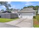 Attached two-car garage with a white door and a concrete driveway surrounded by green grass at 1392 Founders Way, Mount Pleasant, SC 29464