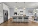 Elegant white kitchen with marble countertops, stainless steel appliances, and pendant lighting at 1392 Founders Way, Mount Pleasant, SC 29464