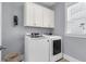 Modern laundry room featuring a front loading washer and dryer, and white cabinetry at 1392 Founders Way, Mount Pleasant, SC 29464