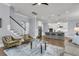 Open concept living room showcasing stairs, bar seating and modern kitchen at 1392 Founders Way, Mount Pleasant, SC 29464