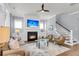 Cozy living room with a fireplace, comfortable seating, and a staircase leading upstairs at 1392 Founders Way, Mount Pleasant, SC 29464