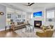 Cozy living room with fireplace, comfortable seating, and natural light from large windows at 1392 Founders Way, Mount Pleasant, SC 29464