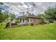 Brick and siding exterior with a landscaped yard, black fence and grill area at 15 A Par Dr # 27, Charleston, SC 29414