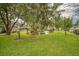 Manicured green lawn backyard with pond feature and mature shade trees at 15 A Par Dr # 27, Charleston, SC 29414