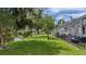 Lush lawn extending to the water, complemented by mature trees and a patio area at 15 A Par Dr # 27, Charleston, SC 29414