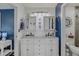 Spacious bathroom with double vanity, bright lighting, and blue accent wall at 15 A Par Dr # 27, Charleston, SC 29414
