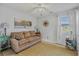 Comfortable bedroom with ample natural light, cozy seating, and neutral decor for relaxation at 15 A Par Dr # 27, Charleston, SC 29414
