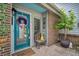 Cozy front door decor with patriotic wreath, potted tree, and vintage chair at 15 A Par Dr # 27, Charleston, SC 29414