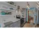 Bright kitchen featuring white countertops, subway tile backsplash, and floating shelves for storage and display at 15 A Par Dr # 27, Charleston, SC 29414