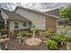 Charming home with a beautifully landscaped side yard, complete with flowers and decorative elements at 15 A Par Dr # 27, Charleston, SC 29414