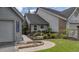 Charming home with a beautifully landscaped side yard, complete with flowers and decorative elements at 15 A Par Dr # 27, Charleston, SC 29414