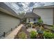 Charming home with a beautifully landscaped side yard, complete with flowers and decorative elements at 15 A Par Dr # 27, Charleston, SC 29414