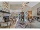 Open-concept living room with high ceilings, a fireplace, and views into the dining area and kitchen at 15 A Par Dr # 27, Charleston, SC 29414