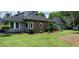 Lush green yard with brick exterior accent and manicured garden beds, perfect for outdoor enjoyment at 15 A Par Dr # 27, Charleston, SC 29414