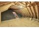 Unfinished attic with wood beams and plywood flooring, showing access to the roof at 154 Patrick Ln, Summerville, SC 29483
