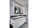 A modern bathroom featuring a double sink vanity, decorative mirrors, and contemporary finishes at 154 Patrick Ln, Summerville, SC 29483