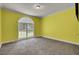 Bright bedroom with large window, neutral carpet, and soothing yellow walls at 154 Patrick Ln, Summerville, SC 29483