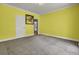 Inviting bedroom with calming yellow walls and view to an ensuite bathroom at 154 Patrick Ln, Summerville, SC 29483
