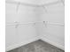 Close-up shot of a white closet, including shelving, bars and carpeted floor at 154 Patrick Ln, Summerville, SC 29483
