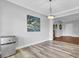 Dining area featuring luxury vinyl plank flooring, contemporary lighting, and stylish wall art at 154 Patrick Ln, Summerville, SC 29483