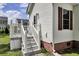 Exterior view of a home featuring white siding, brown shutters, and a deck with stairs at 154 Patrick Ln, Summerville, SC 29483