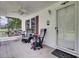 Cozy front porch features rocking chairs, swing, ceiling fan, and a welcome sign at 154 Patrick Ln, Summerville, SC 29483