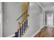 Hallway featuring staircase with carpet and wood handrail; bathroom and closet access at 154 Patrick Ln, Summerville, SC 29483