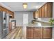 Traditional kitchen boasts wood cabinets, tile countertops, stainless steel appliances, and modern wood-look flooring at 154 Patrick Ln, Summerville, SC 29483