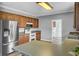 Traditional kitchen boasts wood cabinets, tile countertops, stainless steel appliances, and modern wood-look flooring at 154 Patrick Ln, Summerville, SC 29483