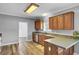 Traditional kitchen boasts wood cabinets, tile countertops, stainless steel appliances, and modern wood-look flooring at 154 Patrick Ln, Summerville, SC 29483