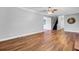 Open living room with wood-look flooring, crown molding and access to kitchen and stairs at 154 Patrick Ln, Summerville, SC 29483