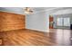 Living room showcasing hardwood floors, wood paneling and access to the kitchen at 154 Patrick Ln, Summerville, SC 29483