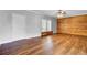 Spacious living room featuring a wood accent wall and two windows for ample lighting at 154 Patrick Ln, Summerville, SC 29483