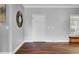 Open-concept living room with wood-look flooring, stylish decor, and ample natural light at 154 Patrick Ln, Summerville, SC 29483