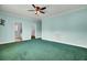 Spacious main bedroom with a ceiling fan, carpet, and access to bathroom and walk-in closet at 154 Patrick Ln, Summerville, SC 29483