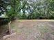 Wide angle view of a level and expansive backyard with an outbuilding at 1640 Dogwood Rd, Charleston, SC 29414