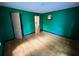 Empty bedroom features hardwood floors, green walls, and two windows offering natural light at 1640 Dogwood Rd, Charleston, SC 29414
